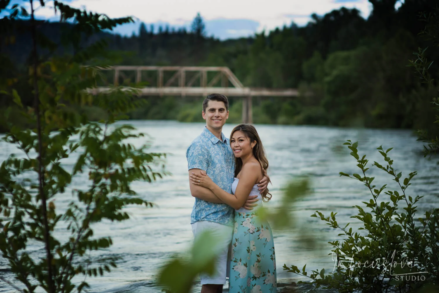 A couple relaxing by the river