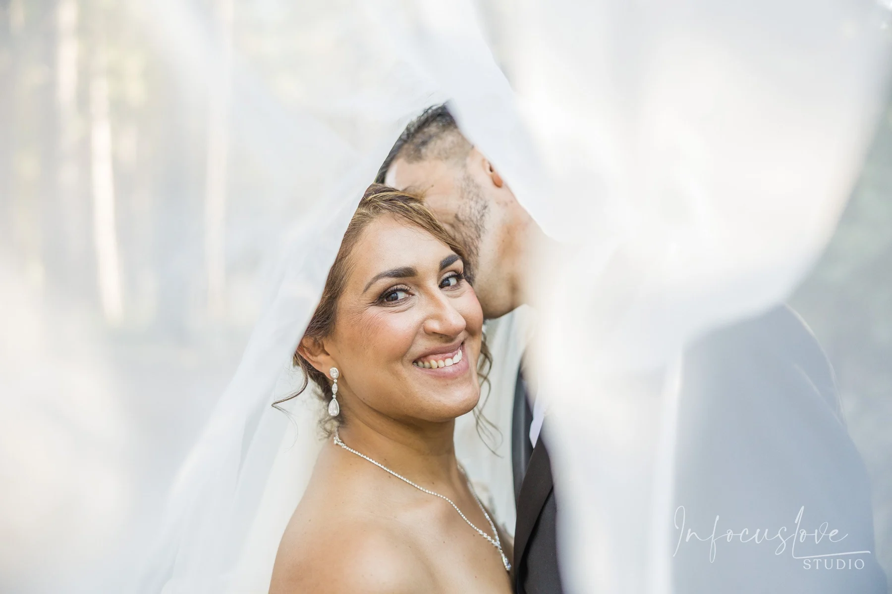 A smiling bride in a veil