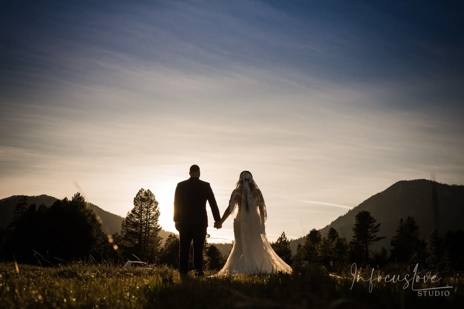 A couple silhouetted against the evening sky