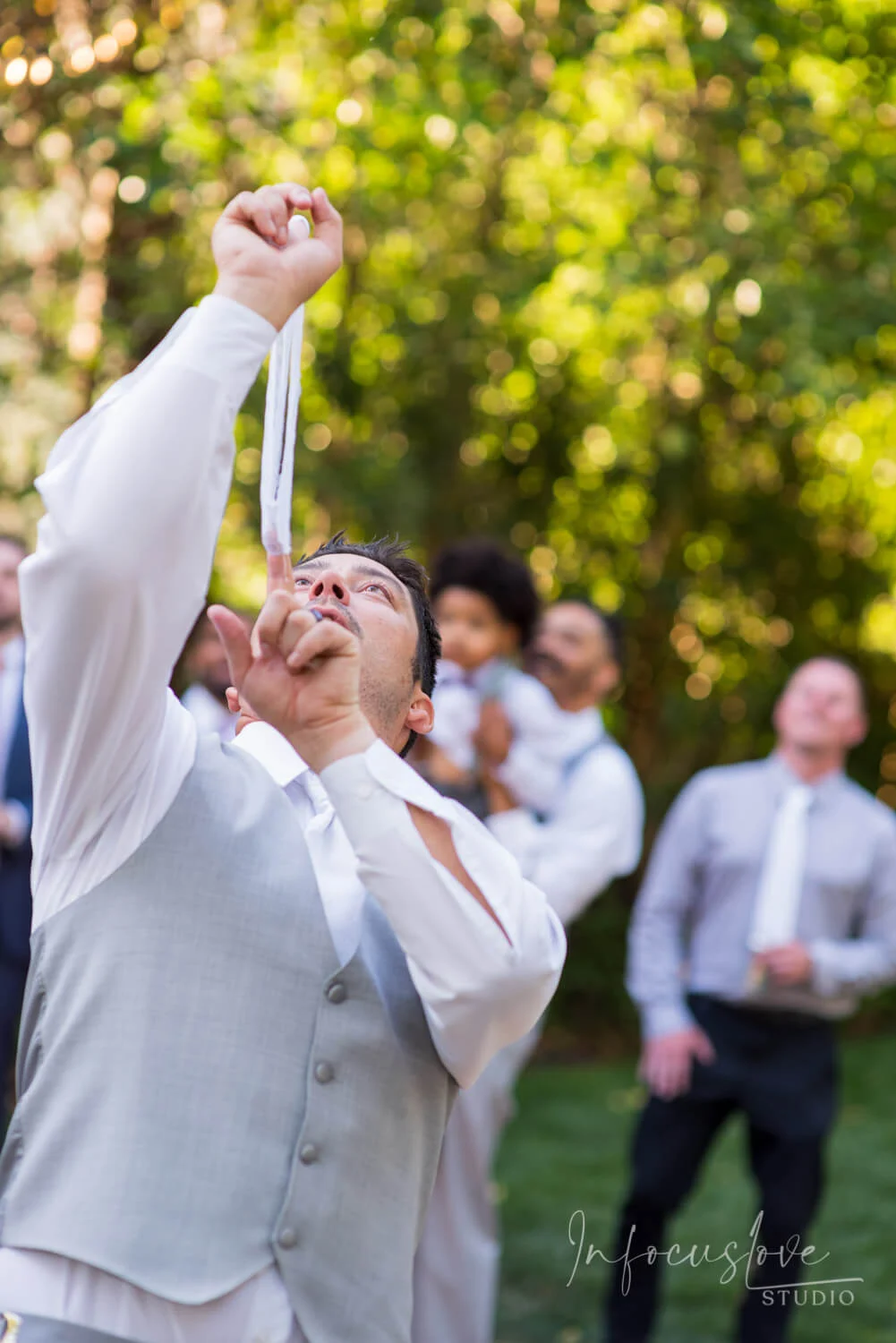 Friends carrying a groom in celebration