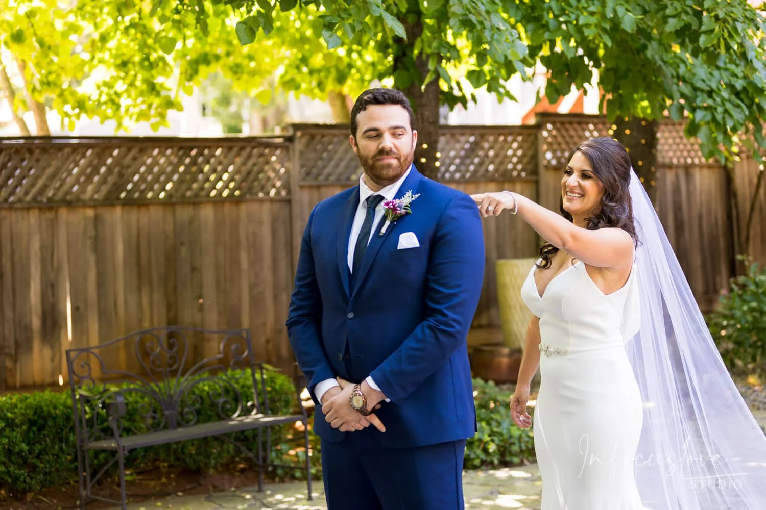 A couple holding hands during an outdoor wedding