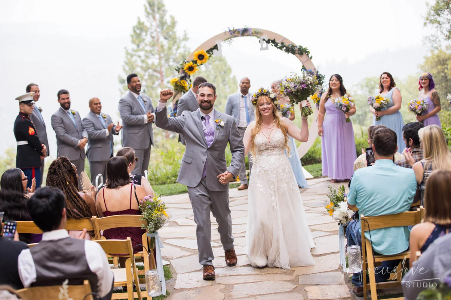 Newlyweds celebrating as guests cheer