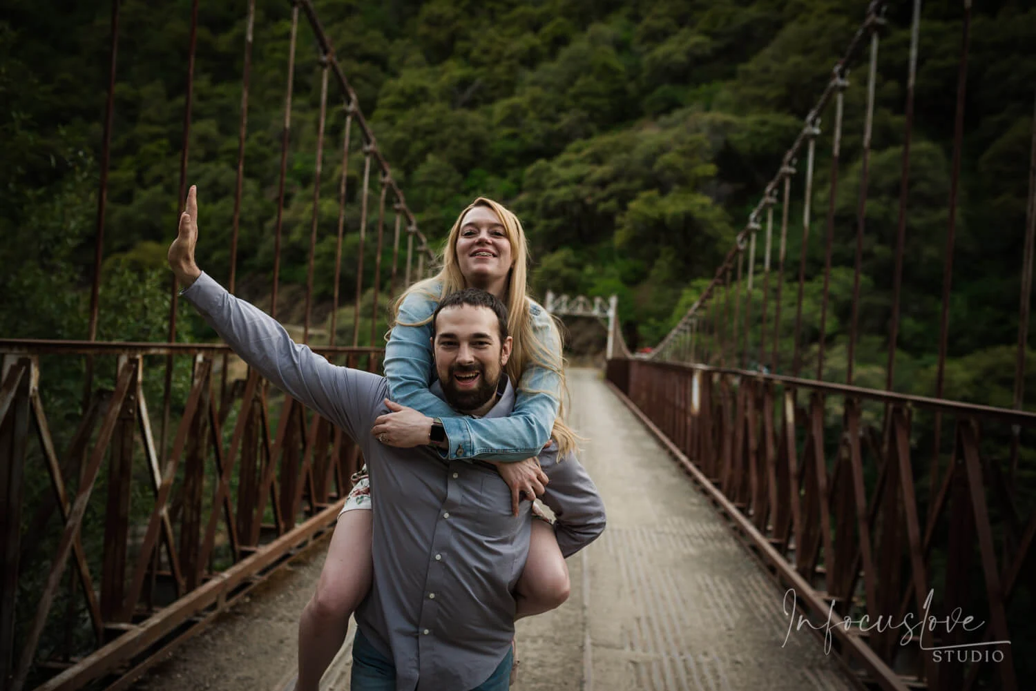 A playful piggyback ride near a bridge