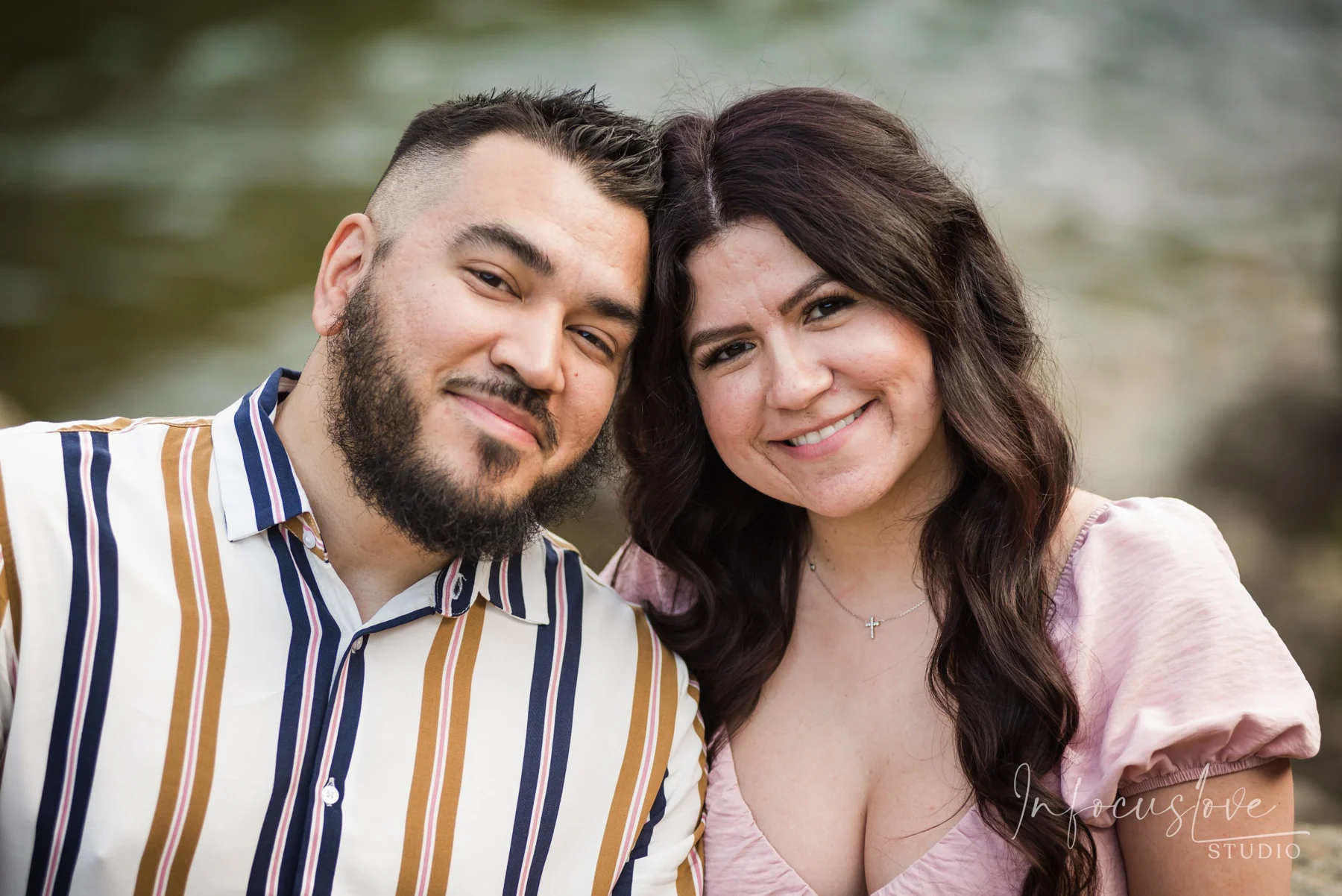 An engaged couple smiling together
